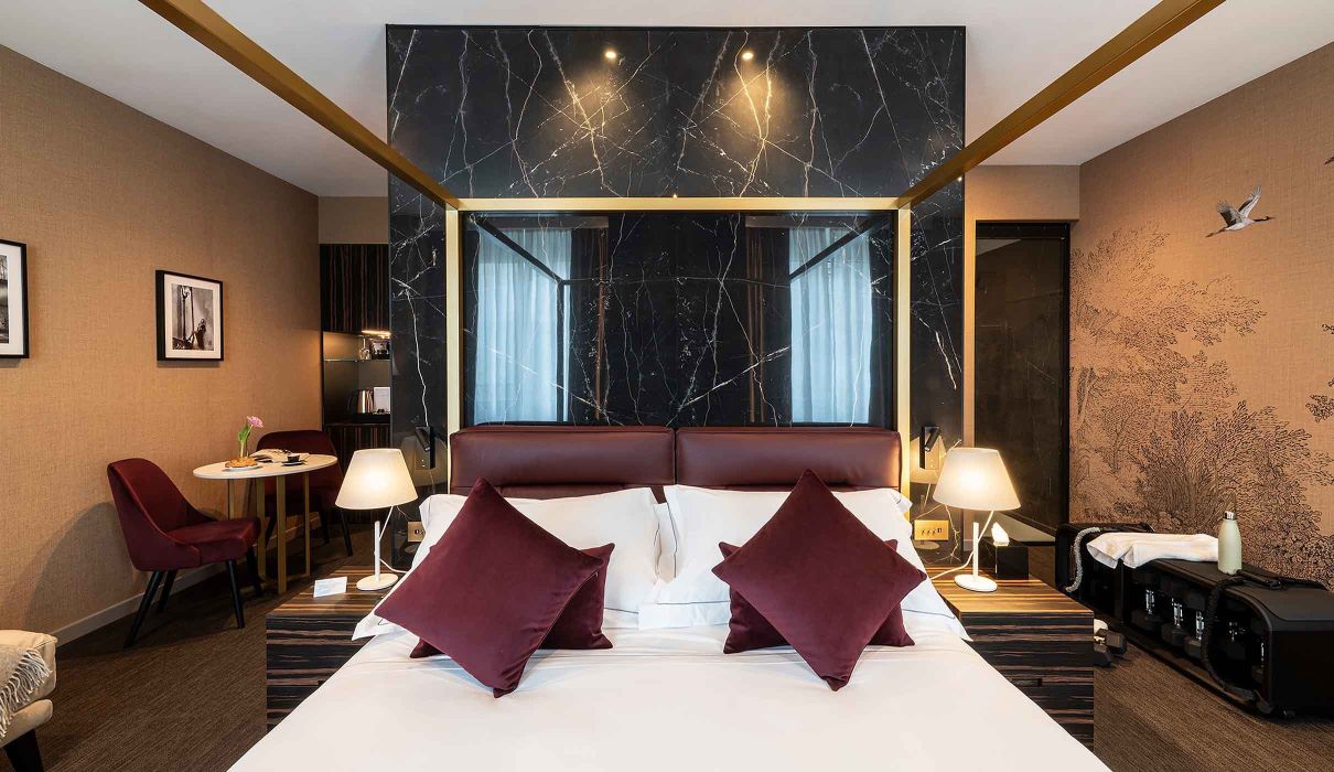 Custom made hotel room furniture in black gold marble and polished brass bed frame