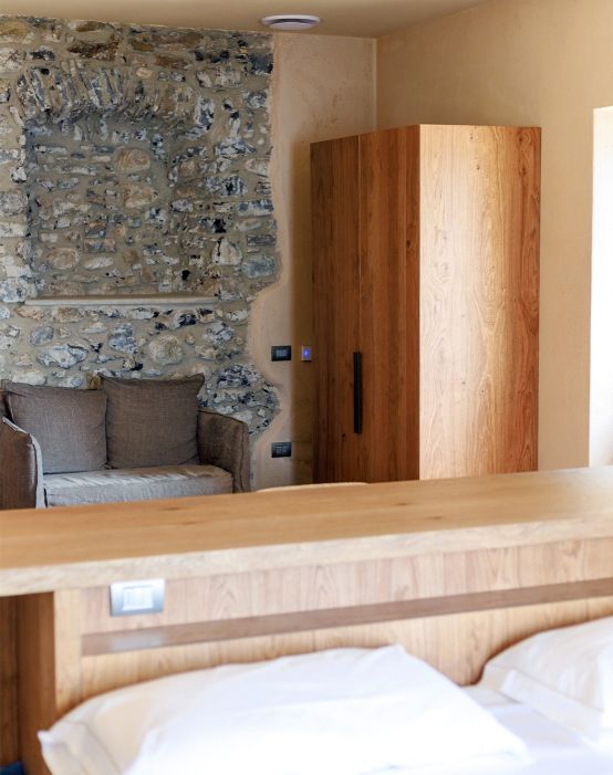 Custom-made hotel furniture: bedroom, detail of wooden headboard