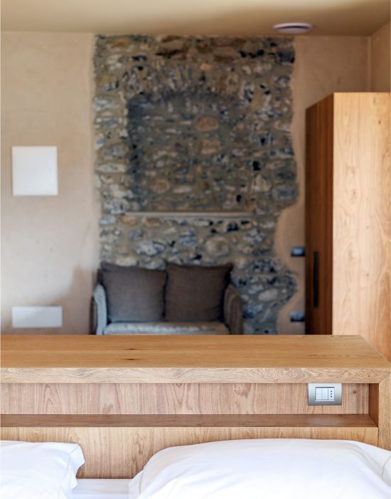 Custom-made hotel furniture: bedroom, detail of wooden headboard