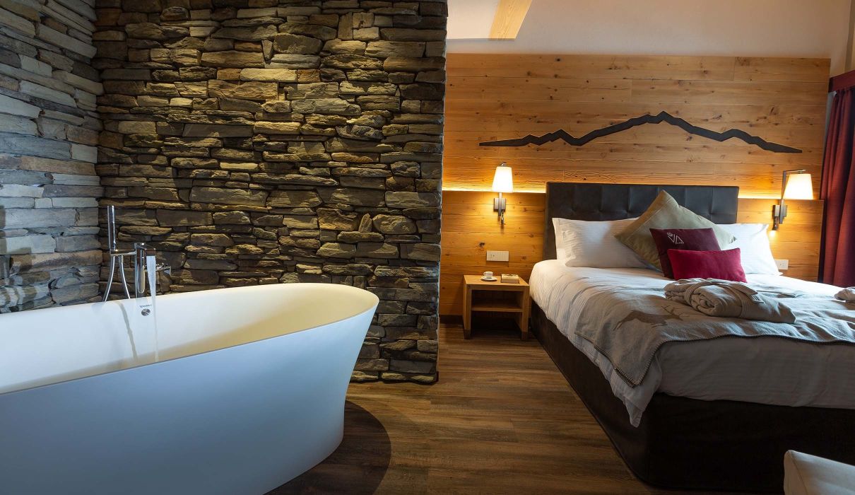 Custom-made furnishings for luxury mountain hotels: suites with in-suite bathtubs