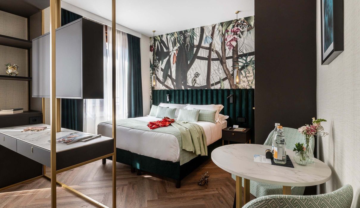 Custom furniture for hotel room: metal structure that houses television, minibar, desk