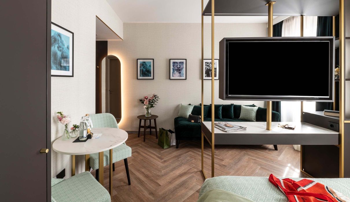 Custom furniture for hotel room: metal structure that houses television, minibar, desk