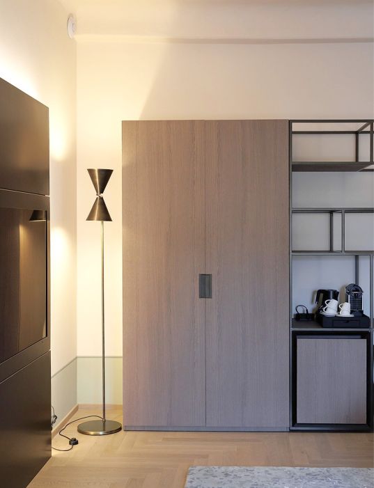 Custom-made hotel furniture in an elegant modern style: wooden wardrobe and snack corner